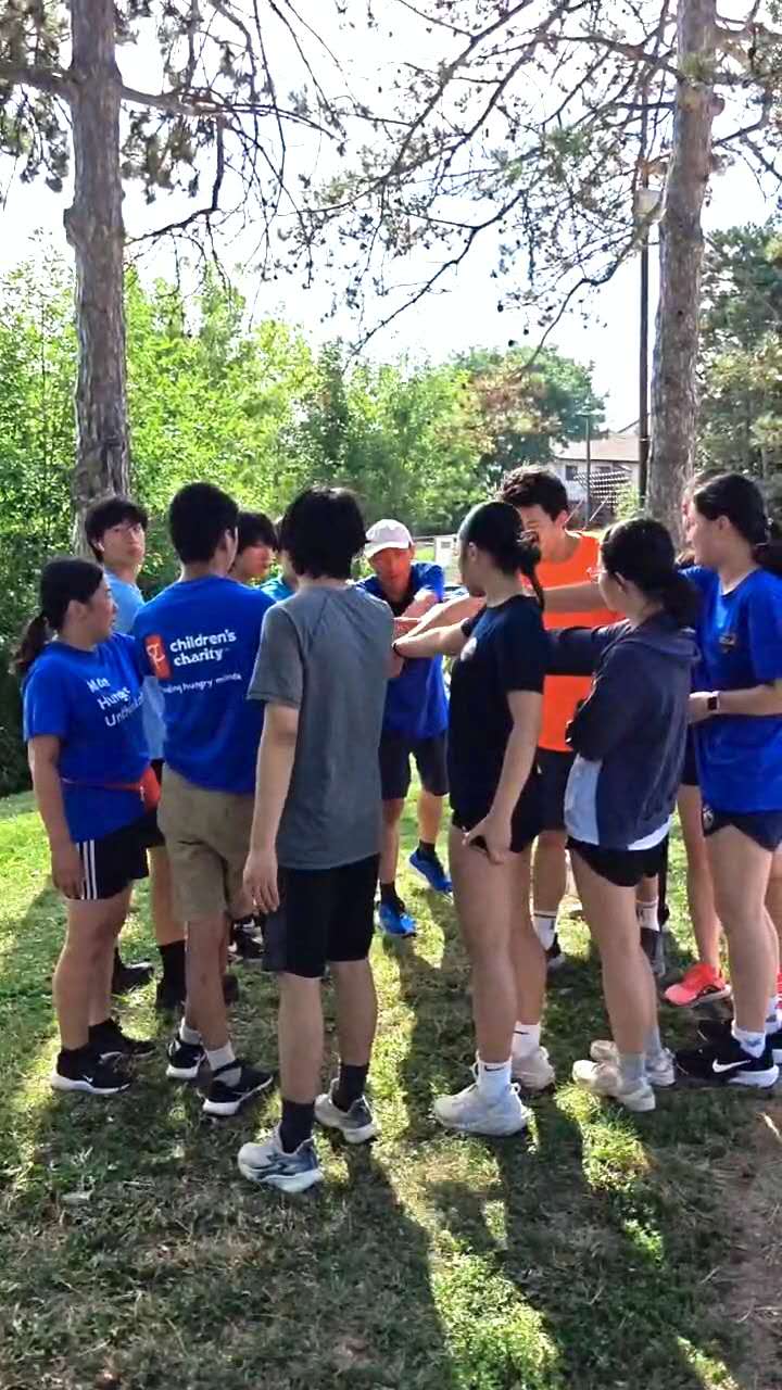 AbleVolley athletes and volunteers in a team huddle at a Saturday parkrun