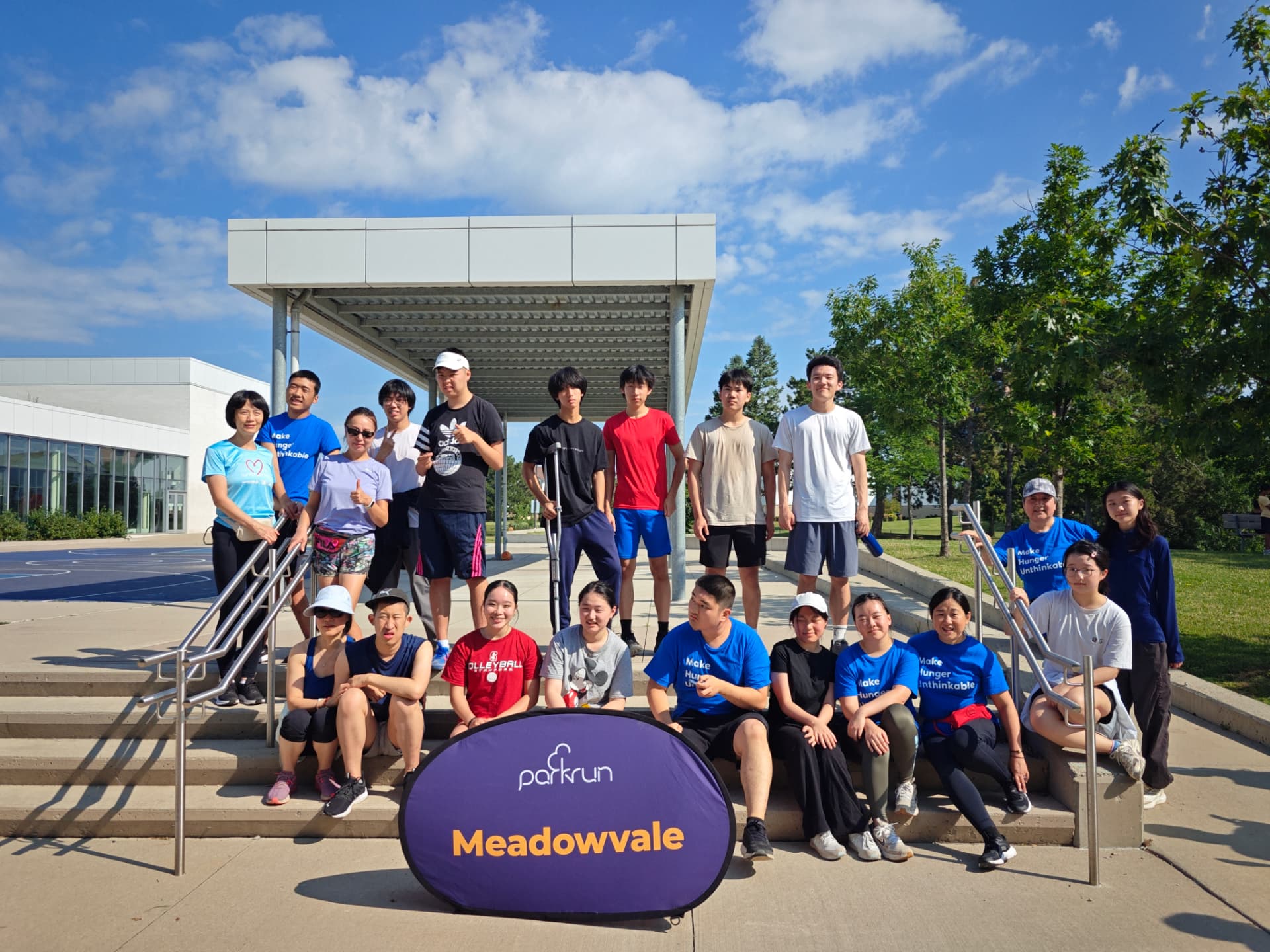 Meadowvale parkrun group photo with volunteers and youth on the community centre steps