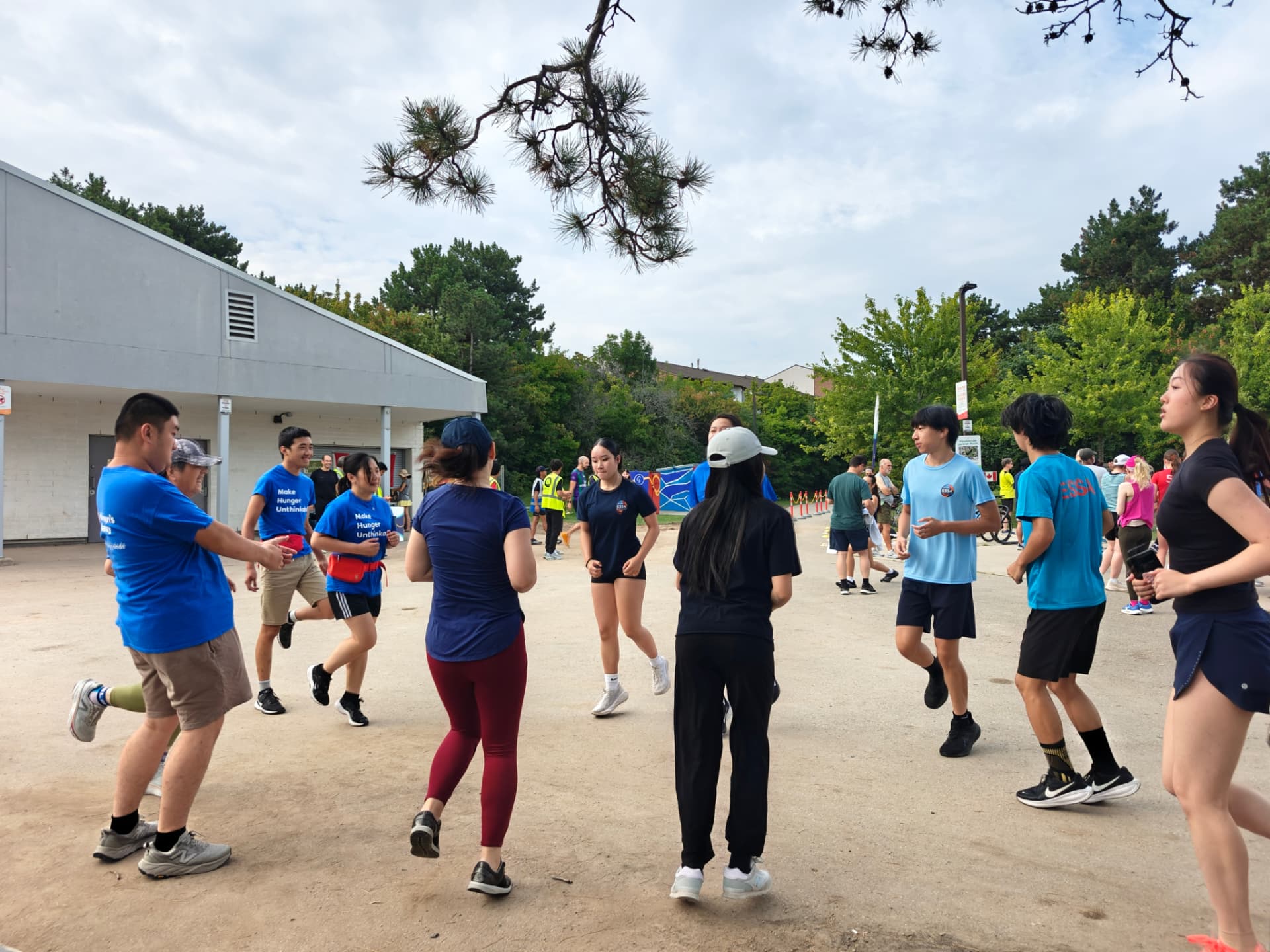 Youth and volunteers warming up together before the Meadowvale 5K parkrun